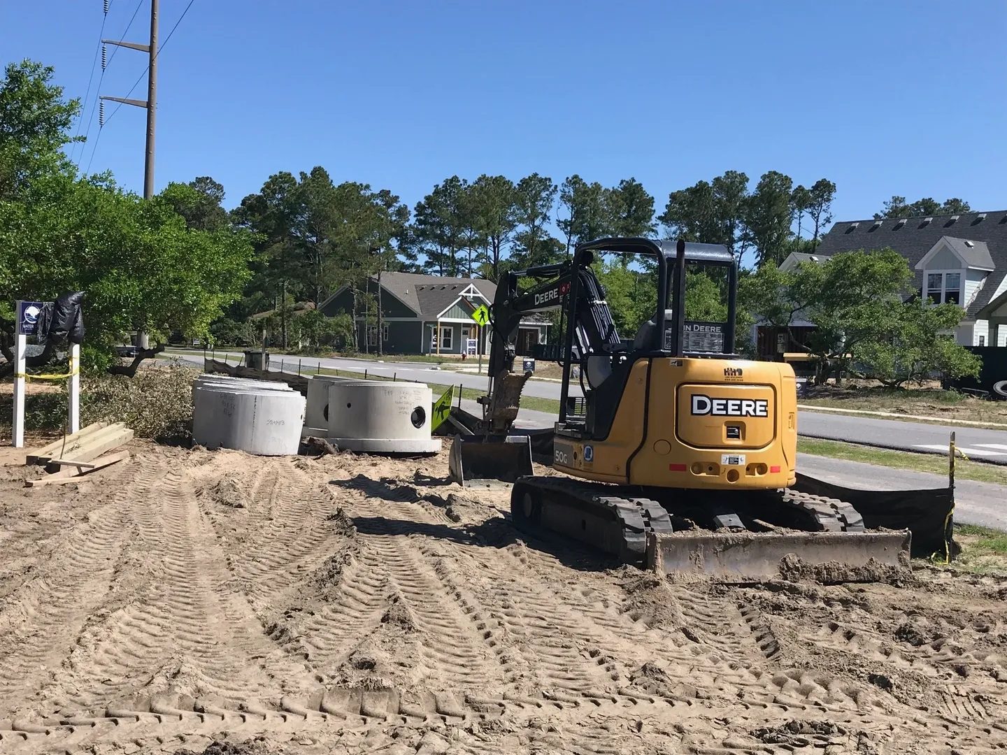 A picture of the john Deere compact Excavator removing sand